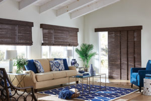 Woven shades rolled up halfway on multiple windows in a living room