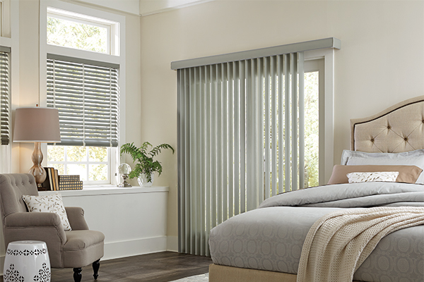 Vertical Blinds covering a glass door in a bedroom